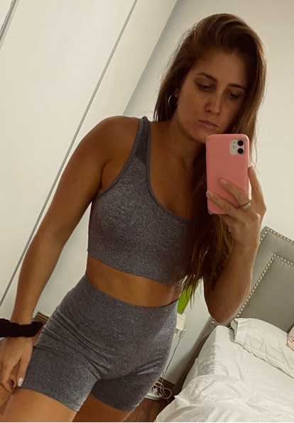 Woman taking a mirror selfie with her phone