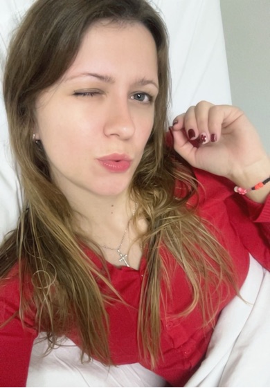 Woman in a red top winking at the camera